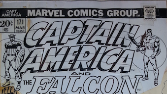 Stat – Copies of original art cut out and glued on to original art.  Quite often word bubbles and the title is stats. Shown is a close-up from the Captain America #171 cover by John Romita.